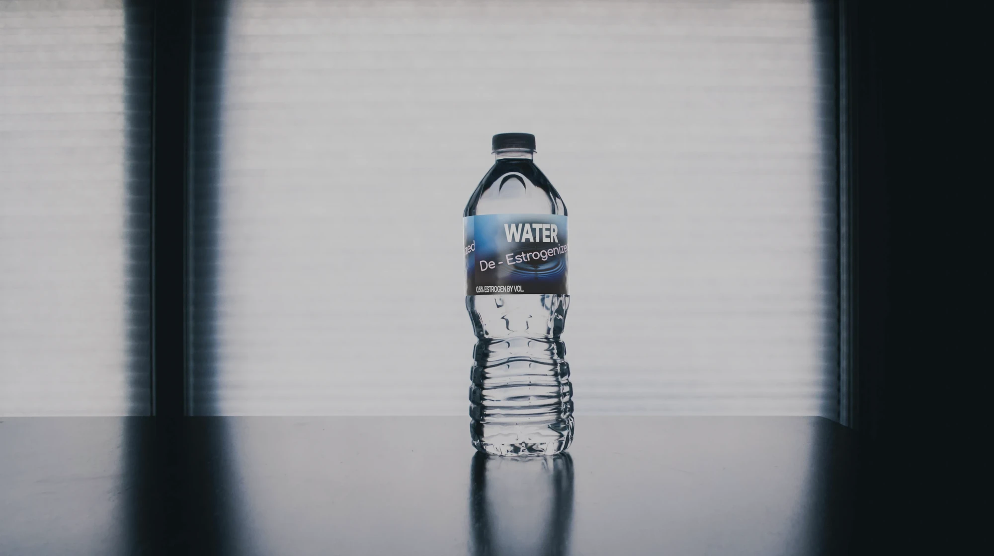 A water bottle labelled with "De-Estrogenized Water, 0.5% Estrogen by Volume"